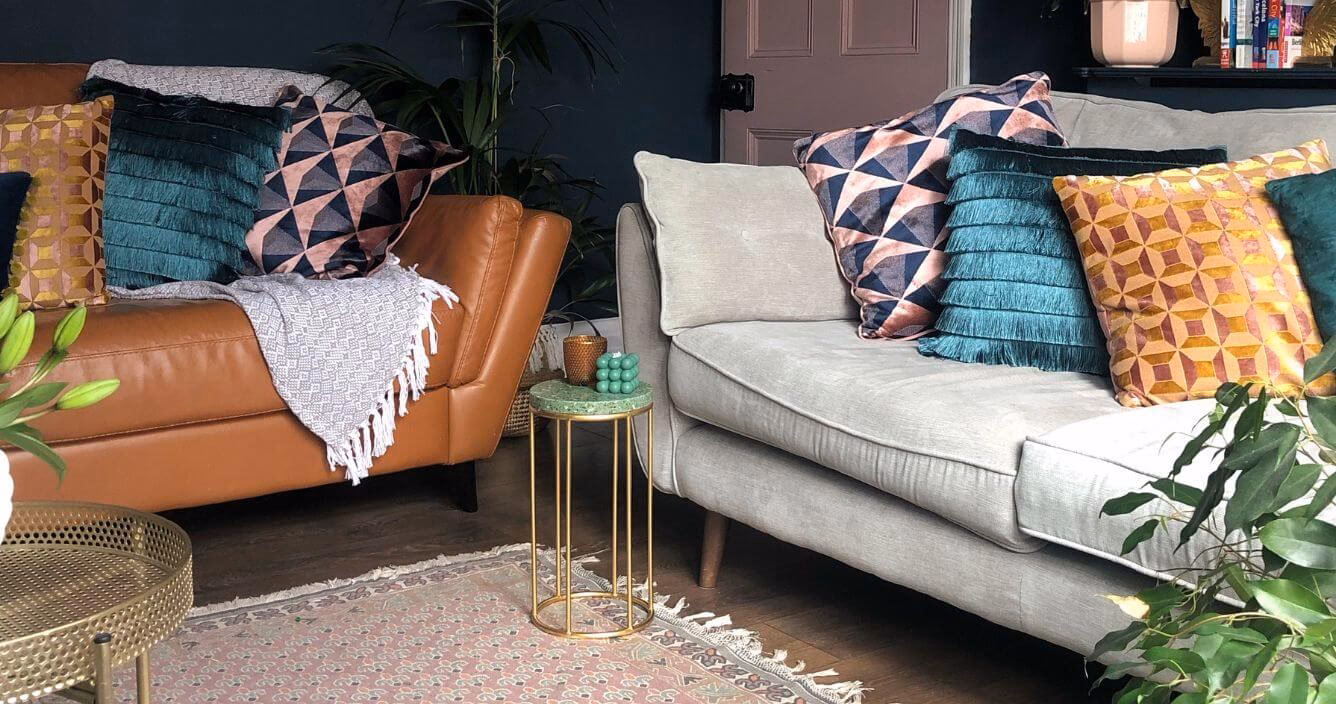How do you add warmth to a grey couch?